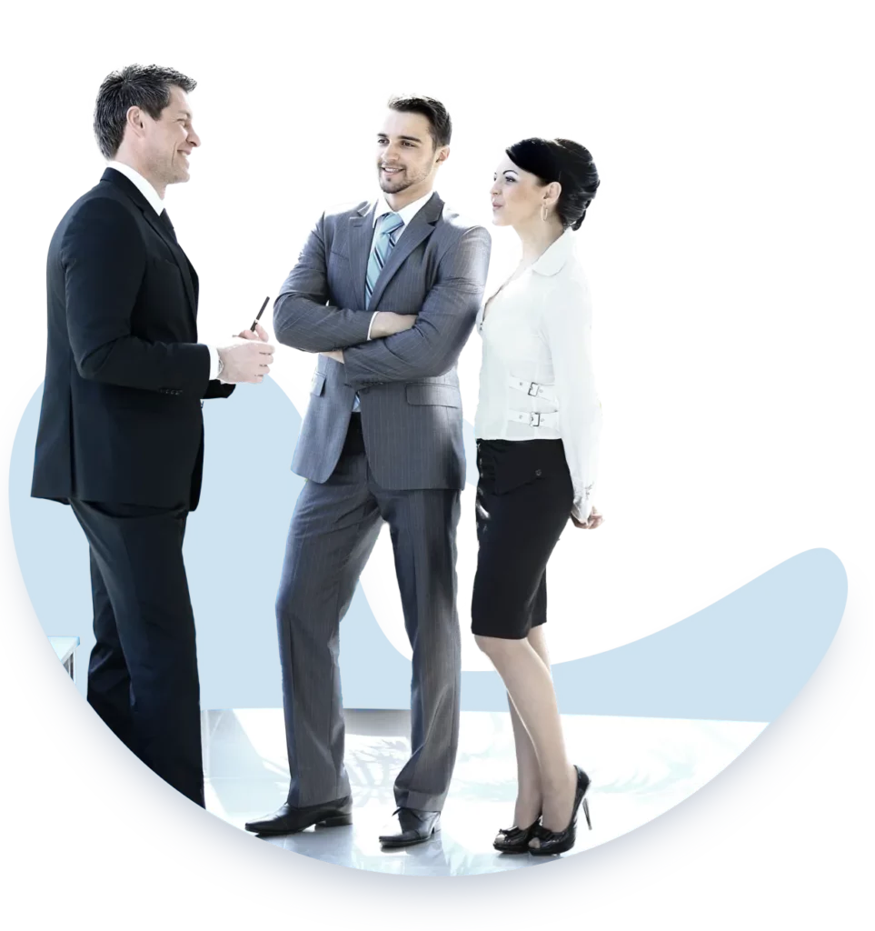 Three professionals in a discussion. The man in the center, wearing a gray suit, stands confidently with his arms crossed. To his left, is a man in a black suit, and to his right, a woman in a white blouse and black skirt listens attentively. The backdrop includes a semi-circular blue graphic, symbolizing a continuous learning curve or process. This scene represents a project management training session with a mentor providing guidance.